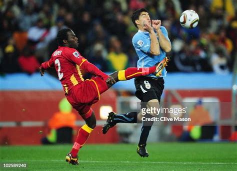 Hans Sarpei of Ghana tackles Luis Suarez of Uruguay during the 2010 ...