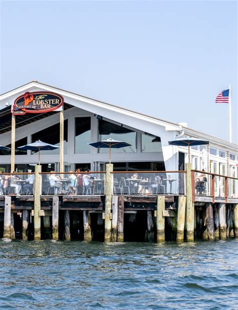 a pier with people sitting at tables and an american flag flying in the ...