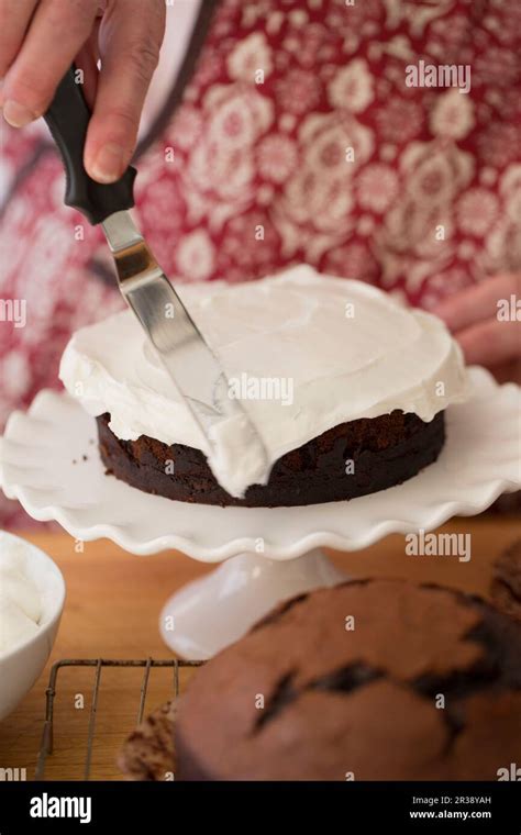 Devils Food Cake covered with frosting Stock Photo - Alamy