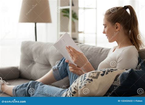 Girl Relaxing at Home Reading Book on Sofa Stock Photo - Image of ...