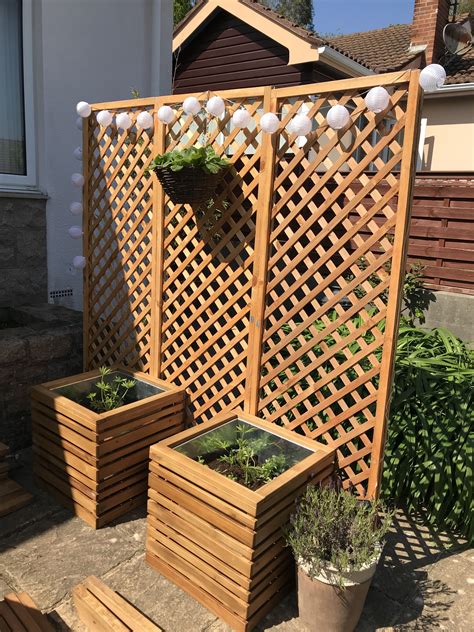 Privacy screen made with trellis and wooden planters | Backyard trellis ...