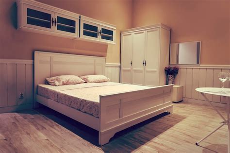 Premium Photo | White wooden bed with white linens stylish interior ...