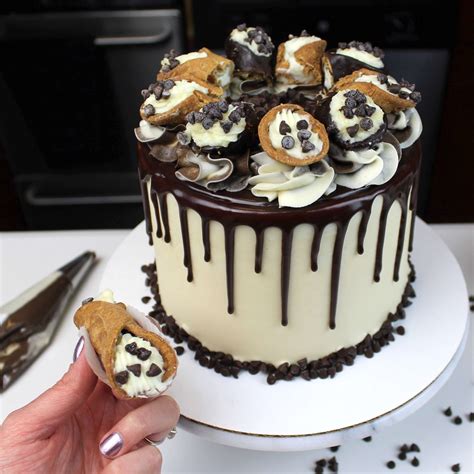 a cake with chocolate and white frosting decorated with cookies on the ...