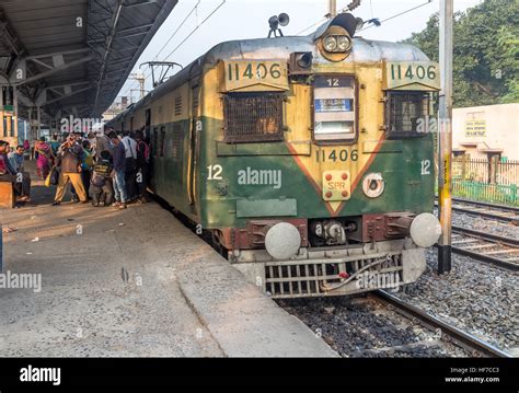 Local passenger train of Indian railways off loading passengers at a ...