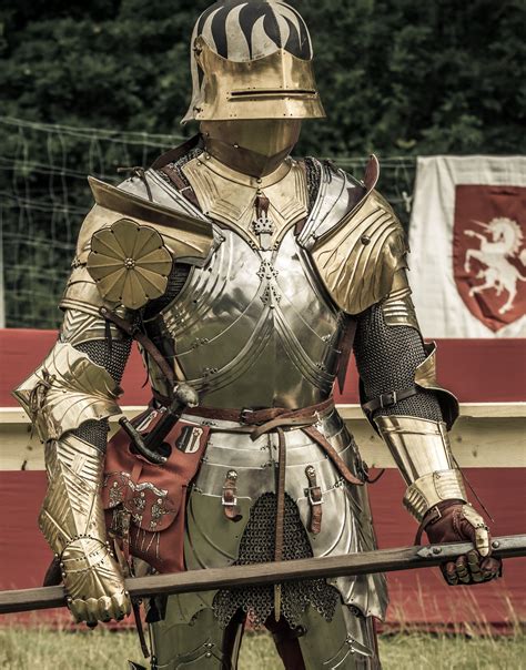 historic style high gothic suit of armour with gilded elements and ...