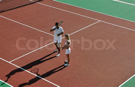 happy young couple play tennis game outdoor | Stock image | Colourbox