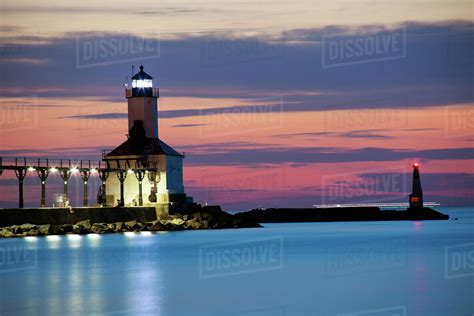 Michigan City Lighthouse at sunset. Chicago skyscrapers seen far in ...