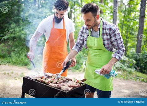 Men Friends Cooking Meat on Barbecue Grill at Outdoor Summer Party ...