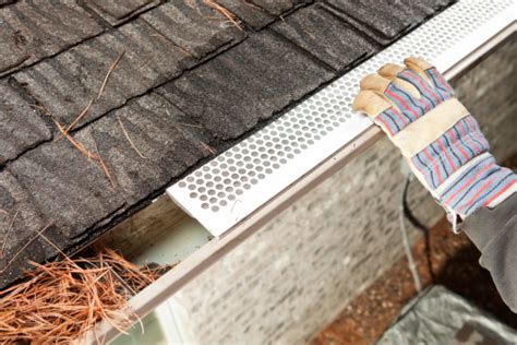 Worker Installing Rain Gutter Guard Leaf Shield Stock Photo - Download ...