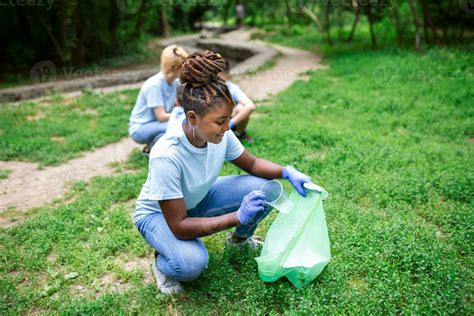 Volunteering, charity and clean environment concept. Happy African ...