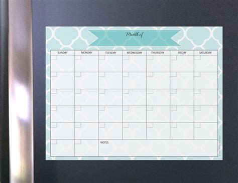 a magnetic board with a calendar on it in front of a refrigerator ...