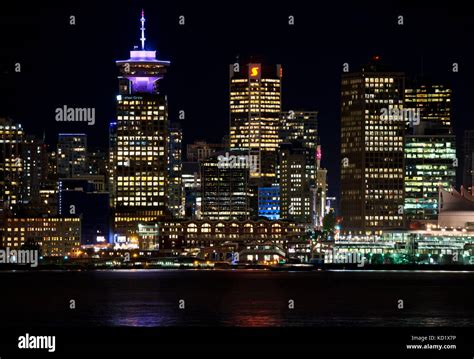 Vancouver Canada skyline on the waterfront at night. Harbour Centre and ...