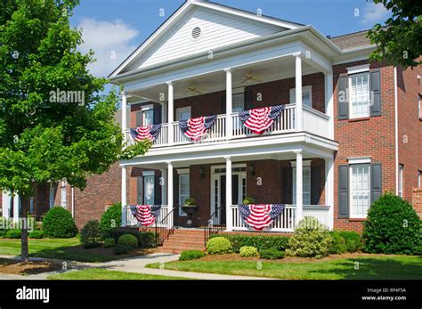 Patriotic American Flag Bunting Hung on a Brick House with a White ...