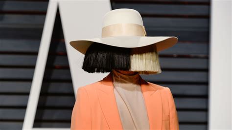 Sia Makes Rare Public Appearance With Face Uncovered: Photos | Allure