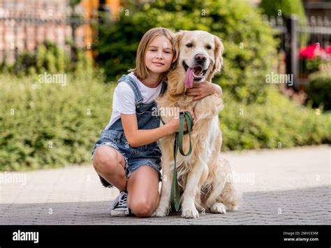 Girl and golden retriever dog Stock Photo - Alamy