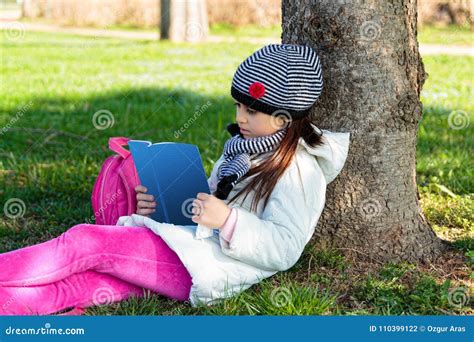 Child Reading the Book Outdoors in the Park Stock Photo - Image of ...