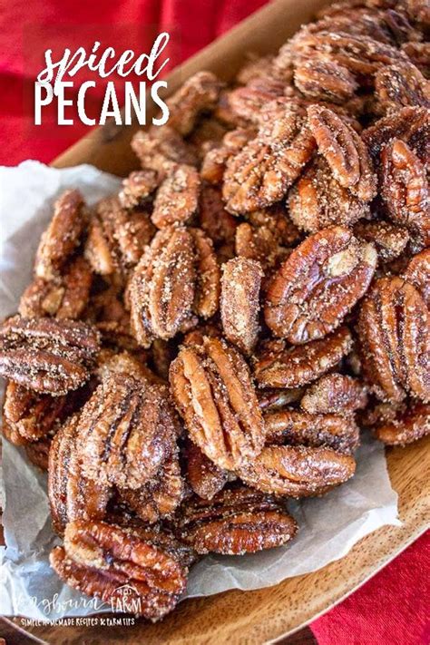 a plate full of sugared pecans sitting on top of a red table cloth