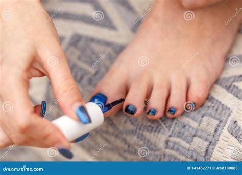 A Young Caucasian Woman Paints Her Toenails. Stock Image - Image of ...