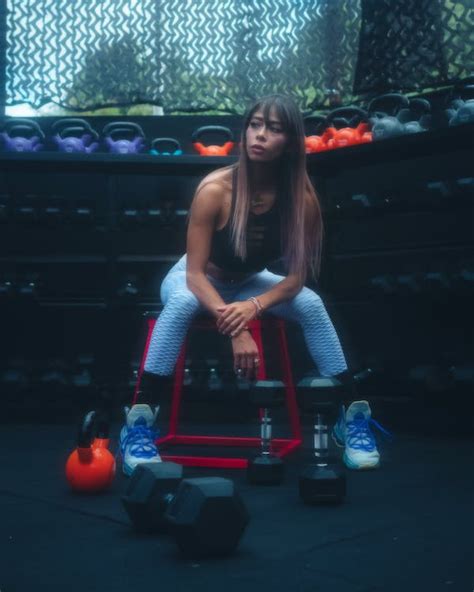 Woman in Tank Top Sitting Beside Gym Equipment · Free Stock Photo