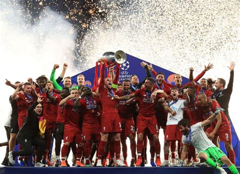 the soccer team is celebrating with their trophy