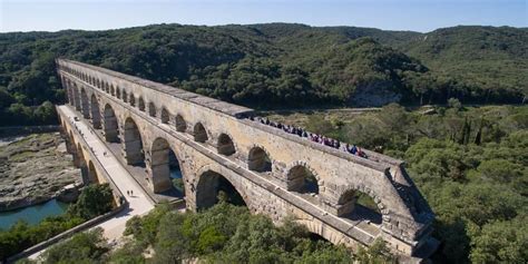 Visitors on a guided tour explore the highest bridge-aqueduct built by the Romans 2,000 years ...