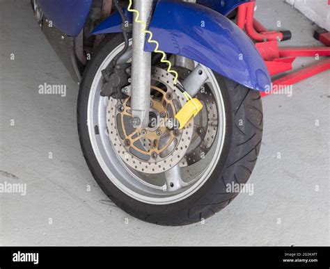 Security lock blocking the motorcycle wheel Stock Photo - Alamy