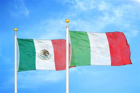 Mexico And Italy Two Flags On Flagpoles And Blue Cloudy Sky Stock Photo ...