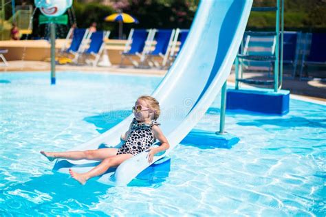 Little Girl On Water Slide At Aquapark On Summer Stock Photo - Image ...