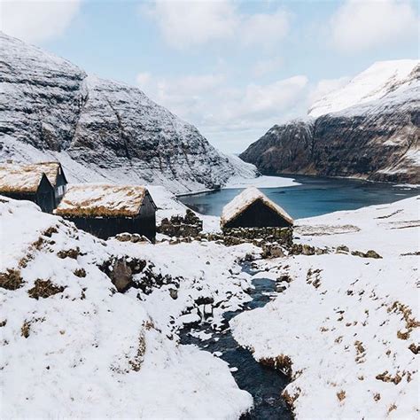 Snow Covered Mountains and Small Houses in the Faroe Islands