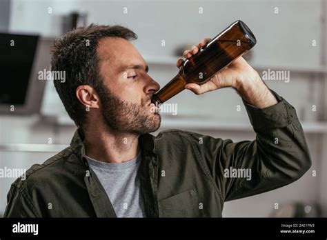 Alcohol addicted man drinking beer from bottle Stock Photo - Alamy