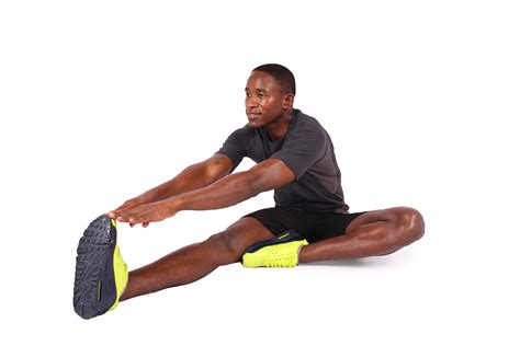 Fitness Man Touching Toes To Stretch Leg Muscles. Stretching Hamstrings ...