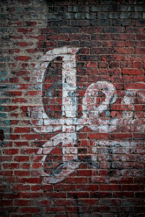 Red Brick Wall with an Old Graffiti · Free Stock Photo