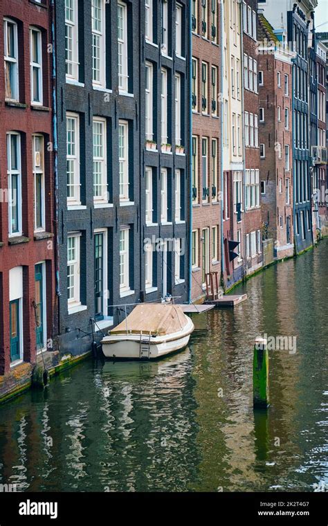 Amsterdam canal Damrak with houses, Netherlands Stock Photo - Alamy