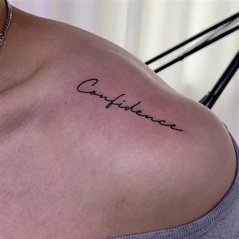 "Confidence" lettering tattoo on the top of shoulder