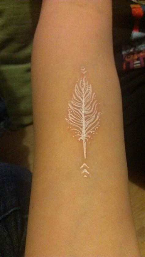 Cool white-ink-feather tattoo for women on arm. >> Find out more by ...