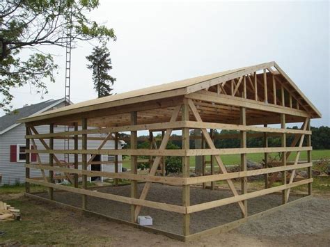 a wooden structure sitting on top of a dirt field