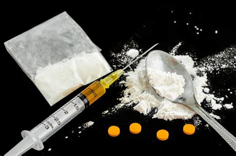 Drug Syringe, Amphetamine Tablets and Cooked Heroin. Stock Image ...