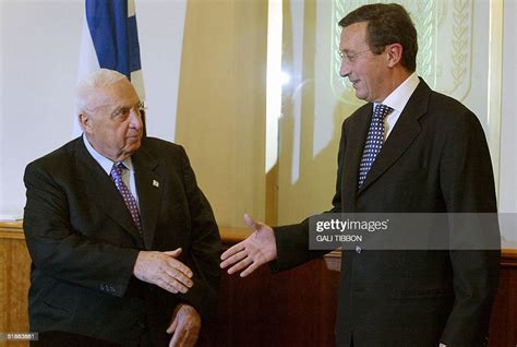 Israeli Prime Minister Ariel Sharon shakes hands with Italian Foreign ...