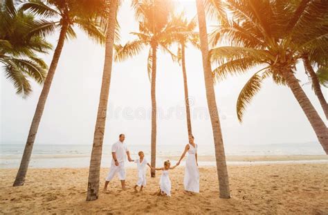 Happy Young Family on the Sunset at the Beach. Stock Photo - Image of ...