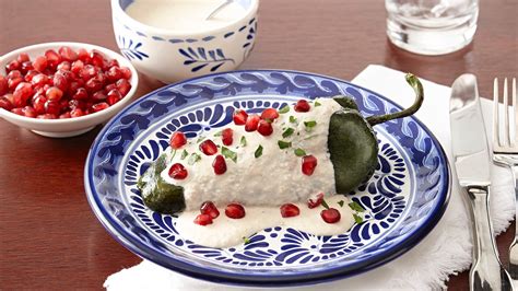 CHILES EN NOGADA Roasted poblano chilies stuffed with a savory-sweet ...