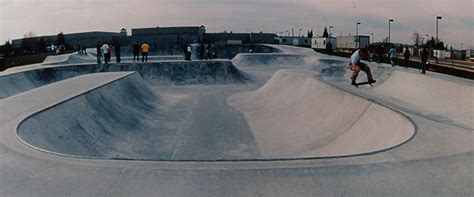 a group of people riding skateboards on top of ramps at a skateboard park