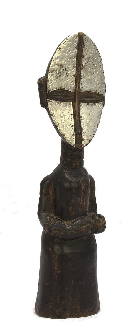 Lot - A Ghanan carved wood and metal maternity figure, length: 18 1/2 ...