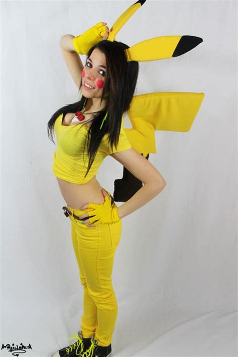 a woman in yellow is posing for the camera