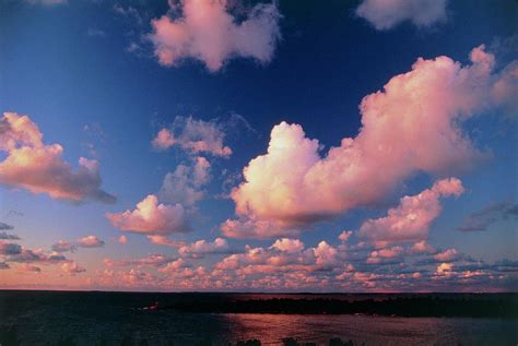 Fair-weather Cumulus Clouds Over Water At Sunset Photograph by Pekka ...