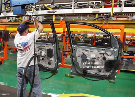 A worker assembles car door units at Ford's Chicago Assembly Plant ...