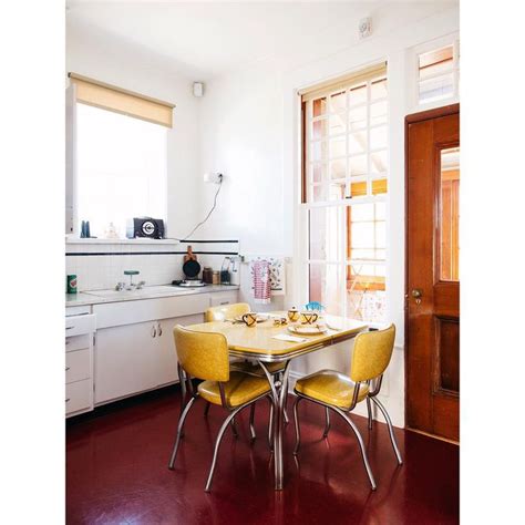 a kitchen with a table and chairs next to a door that leads to the outside