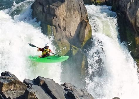 Expert kayakers fly over whitewater rapids at the Great Falls Race of ...