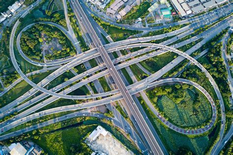 Aerial view of road interchange or highway intersection with busy urban ...