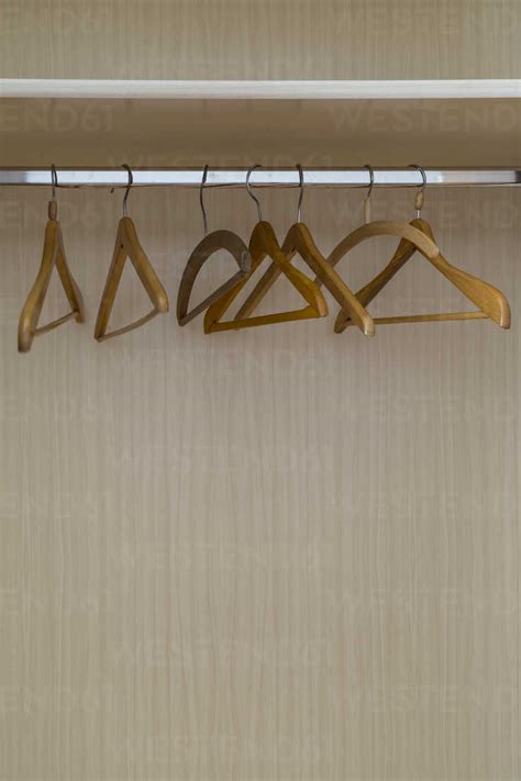 Empty coat hangers in a closet stock photo