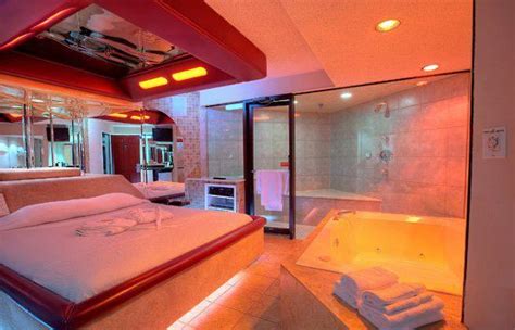 a bedroom with a large bed and a bathtub in it's center area